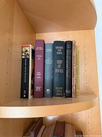 Shelf view showing all seven books standing upright with spines visible