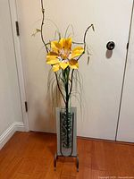 Full view of entire arrangement showing flower, vase, and stand