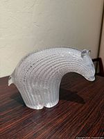 Left side view of clear glass bear showing full form and lattice pattern