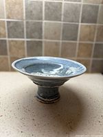 Side view showing pedestal base and glaze