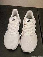 Top view of the unworn Adidas sneakers showing laces, mesh texture and logo