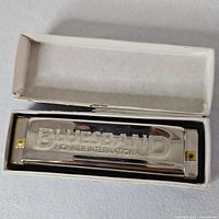 Hohner BluesBand harmonica inside open white box