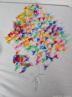 Full assortment of coloured plastic peg lights arranged by colour with clear star topper at bottom