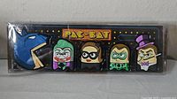 Front view of sealed Pac-Bat magnet set showing all five character magnets