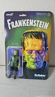 Front view of sealed Super7 ReAction Frankenstein figure on blister card
