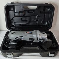 Saw inside molded carry case with power cord visible