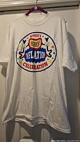 Front view of white T-shirt with Mickey’s Great Inflation Celebration graphic