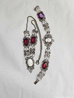 Full view of necklace and bracelet displaying filigree design, cameos and glass stones