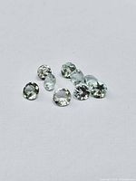 Eight round pale blue gemstones on white background