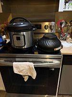 Instant Pot pressure cooker and separate air fryer lid on stovetop