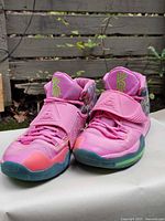 Frontal view of both shoes showing tongues, straps and outsole color