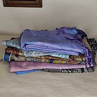 Stack of folded scarves showing variety