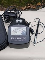 Front view of Presidium Gem Tester II with adapter, probe pen, showing meter