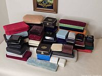 Full lot of stacked assorted jewelry boxes in varied colors and sizes