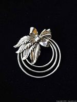 Front view showing triple hoops, leaf and bow design