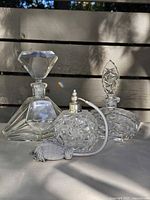 Group shot of three crystal perfume bottles