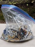 Full sealed bag of mixed jewelry pieces