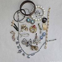 Group shot of entire 19-piece jewelry lot on neutral background