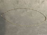 Full view of entire gold chain necklace laid flat