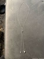 Full view of sterling silver lariat necklace showing overall length and design