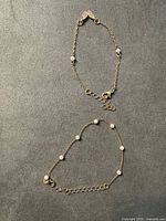 Both bracelet and anklet laid flat showing overall design and length