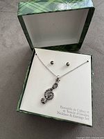 Necklace and earrings displayed in box lid