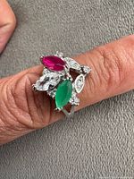 Ring worn on finger showing stone arrangement and band