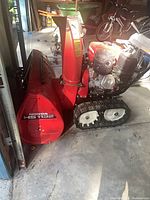 Full view of Honda HS 1132 track snow blower in garage