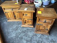 three rustic wood cabinets with iron hardware
