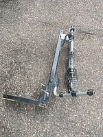 Full view of folded Thule hitch rack showing dual arms and receiver shank