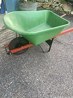 Side view showing green plastic tub, wood handles, metal frame, pneumatic wheel