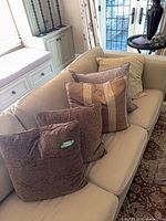 Five pillows on sofa showing variety and quantity