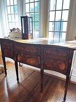 Full view of front showing serpentine shape and veneer panels