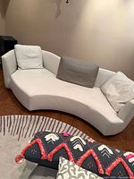 Front view of Roche Bobois curved sofa showing cushions