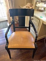 Front view black finish armchair with tan seat