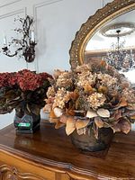 Both floral arrangements on dresser; left arrangement (burgundy hydrangeas) carries green 0527 tag identifying lot item