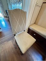 Front view of one chair showing seat and diamond-pattern back