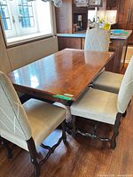 Table with four chairs around, showing full top and pedestal base