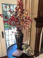 Tall vase with floral arrangement and small vase with hydrangeas