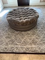 Full view of grey carpet with diamond pattern under ottoman