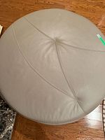 Top view showing round shape, leather surface and stitching