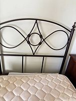 Full view of metal headboard with mattress in place