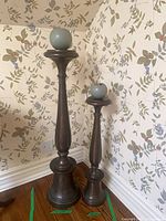 Both candleholders with candles displayed together for scale