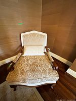 Front view of chaise lounge with pillow showing fabric pattern and wooden arms