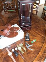 Group shot: sandals on Tanya Heath box, jewelry cabinet, watches and heel tool