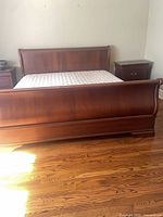 Full view of sleigh bed frame with mattress
