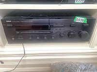 Front view of Yamaha RX-596 receiver in shelf