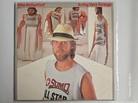 Front album cover with artist photos and title