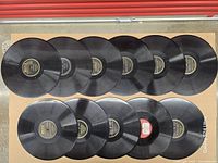 Eleven records laid out label-side up