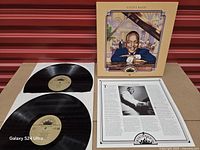 Set laid out with two vinyl records, outer box and insert visible